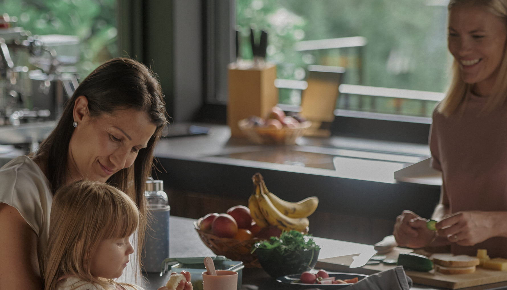 parenting at home two women in a kitchen with a young girl